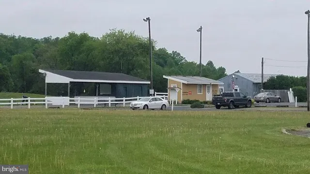 a view of a house with swimming pool and furniture
