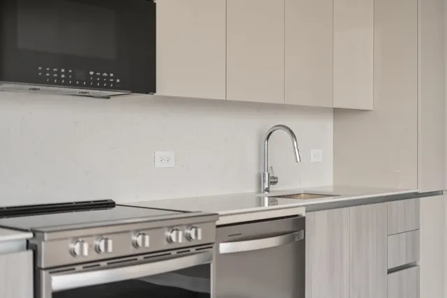 a close view of a sink and cabinets