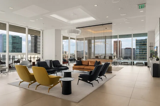 a living room with furniture and large windows