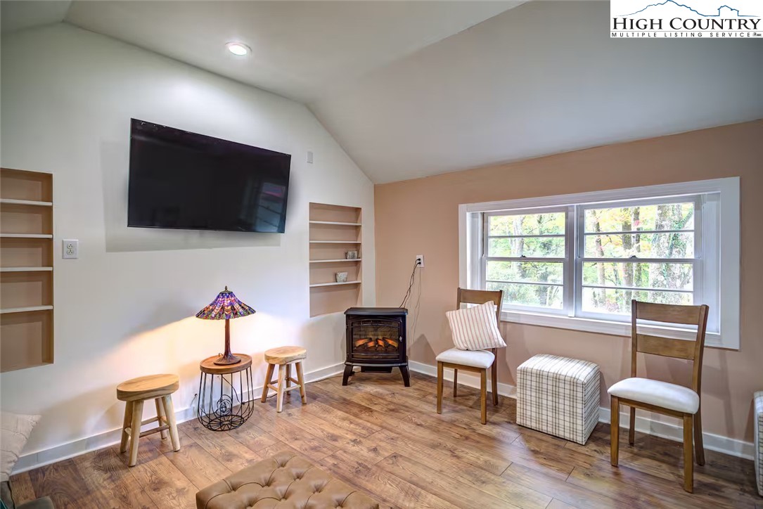 17 Grey Fox Ridge Road Banner Elk, NC 28604 - Photo 34 of 37 a living room with furniture a flat screen tv and a large window