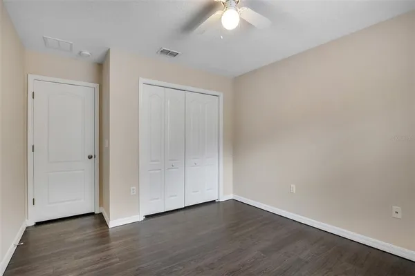 a view of an empty room with wooden floor