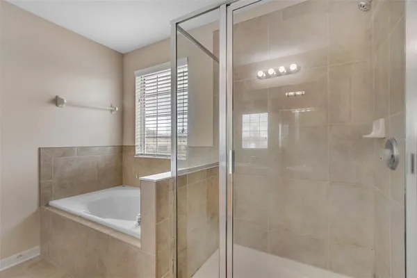 a bathroom with a bathtub and a shower