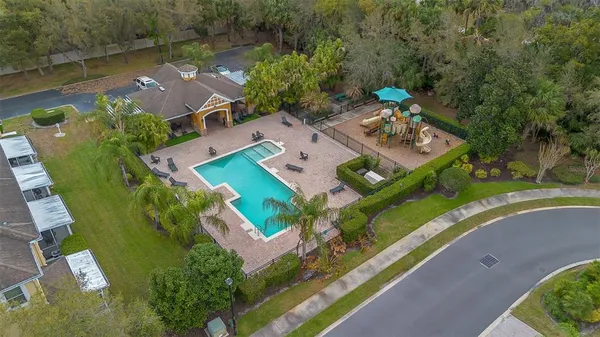 an aerial view of a house with a garden and lake view