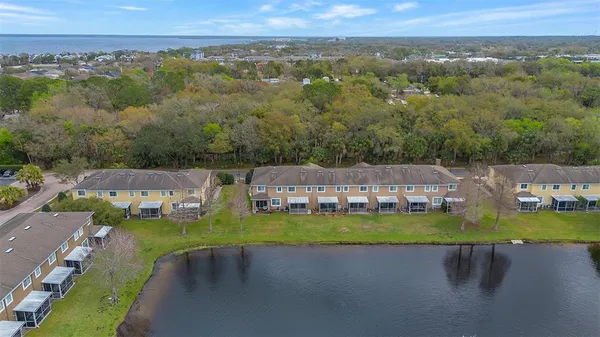 an aerial view of a house with a garden and lake view