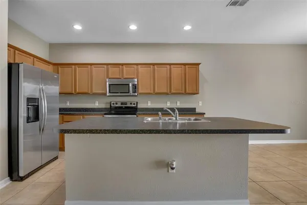 a kitchen with granite countertop a sink and stainless steel appliances