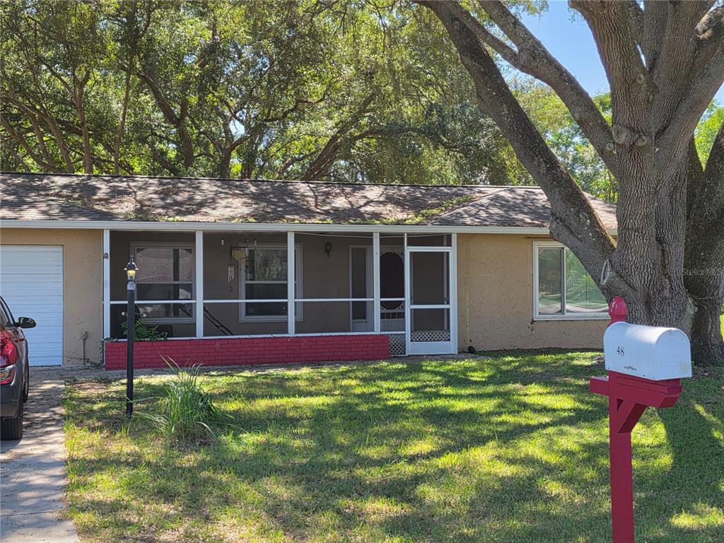 Undisclosed Address Ocala, FL 34472 - Photo 2 of 21 a view of house with backyard space and garden