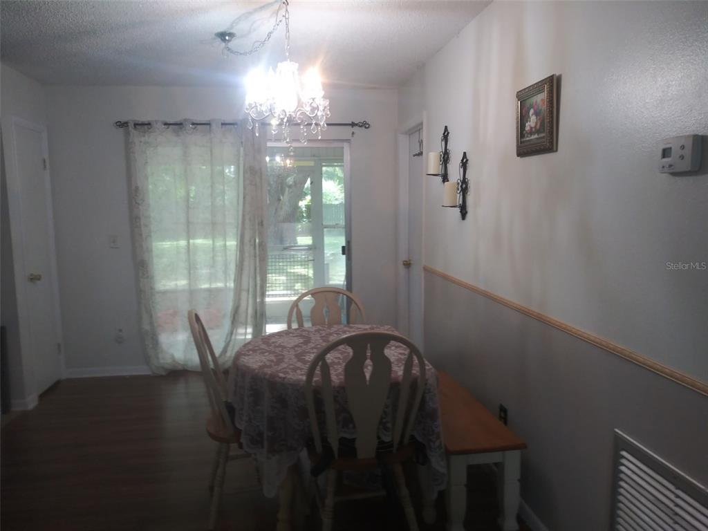 Undisclosed Address Ocala, FL 34472 - Photo 7 of 21 a view of a dining room with furniture and chandelier