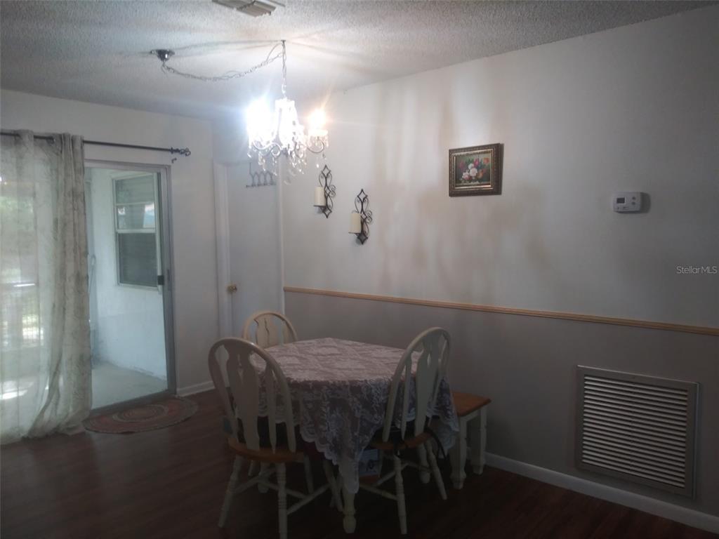 Undisclosed Address Ocala, FL 34472 - Photo 8 of 21 a view of a dining room with furniture and wooden floor