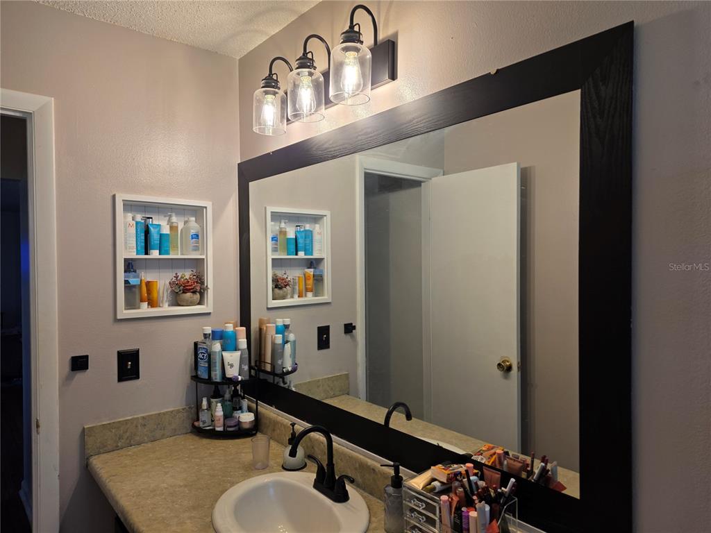 Undisclosed Address Ocala, FL 34472 - Photo 10 of 21 a bathroom with a sink mirror and vanity