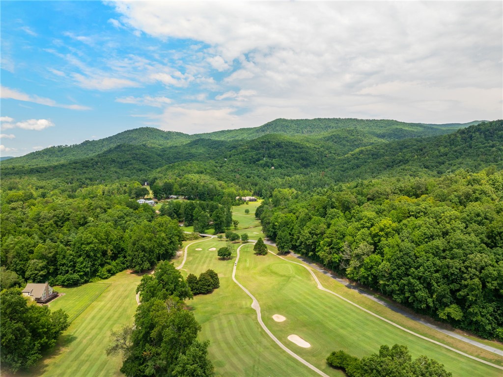 300 Whispering Falls Road Pickens, SC 29671 - Photo 36 of 41 Rolling green fairways meet forested mountains under a blue sky.