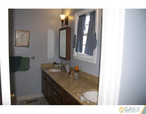 521 New Brunswick Road Somerset, NJ 08873 - Photo 6 of 11 a bathroom with a sink vanity and a mirror