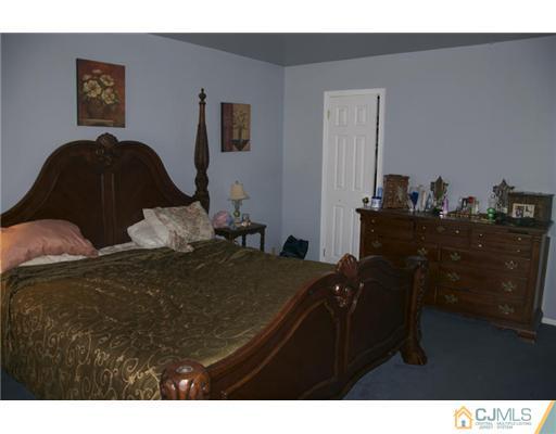 521 New Brunswick Road Somerset, NJ 08873 - Photo 8 of 11 a bedroom with a bed and a desk