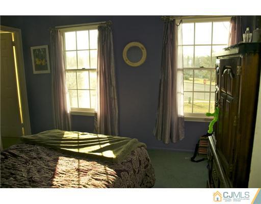 521 New Brunswick Road Somerset, NJ 08873 - Photo 10 of 11 a bedroom with a bed and a window