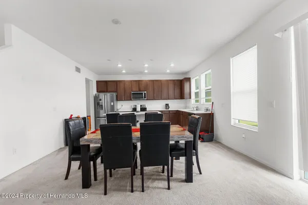 a view of a dining room with furniture and a window