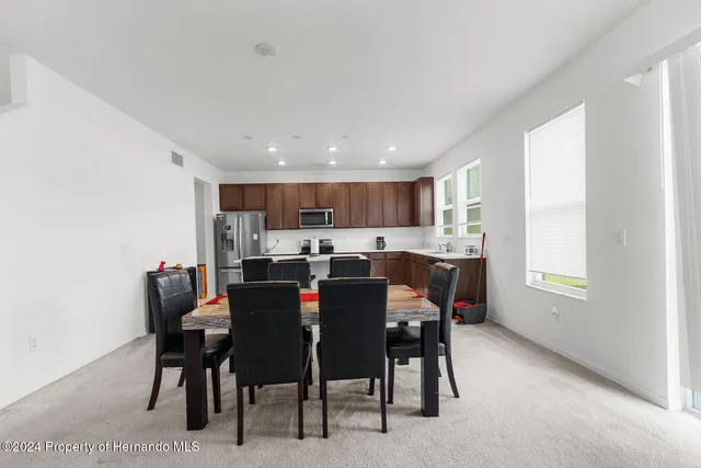 a view of a dining room with furniture and a window