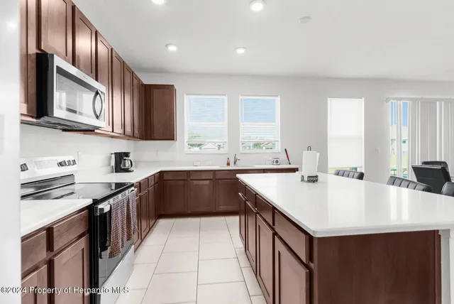 a kitchen with a stove sink and cabinets