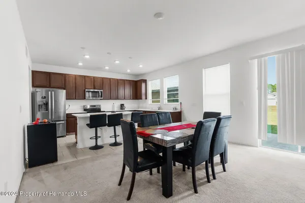 a view of a dining room with furniture and window