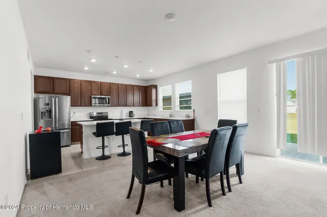 a view of a dining room with furniture and window