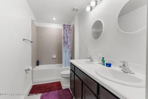 a bedroom with a bed and a chair