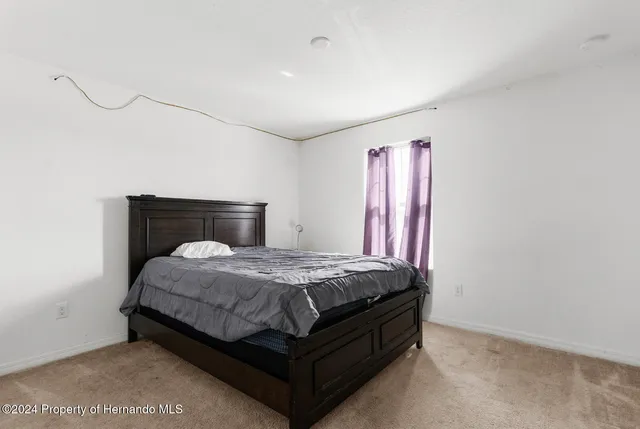 a bedroom with a bed and a mirror