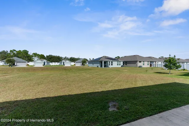 a view of a house with a yard and sitting area