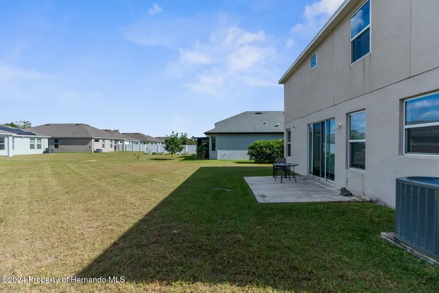 a view of a house with a yard and garage