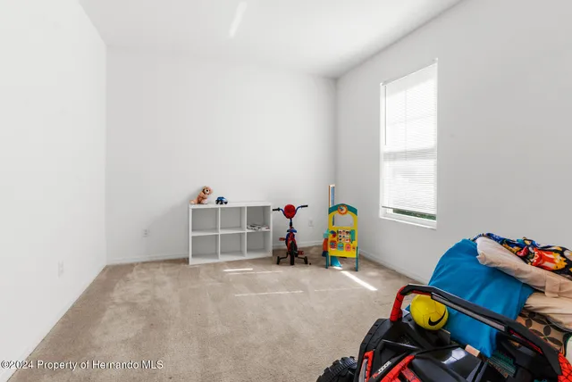 a view of a room with gym equipment and windows