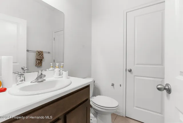 a bathroom with a sink toilet and vanity