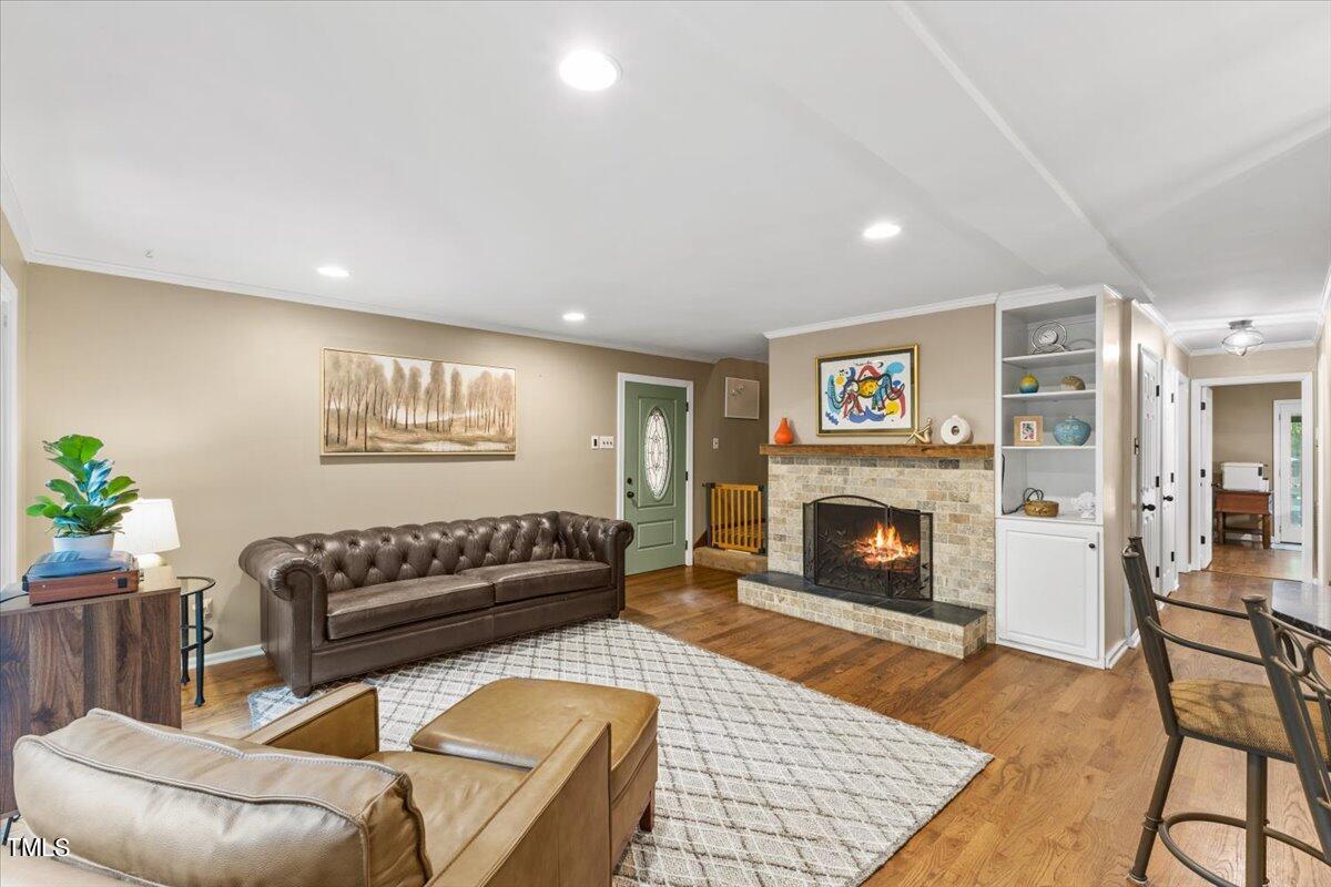 6713 Laurdane Road Raleigh, NC 27613 - Photo 11 of 47 a living room with furniture and a fireplace