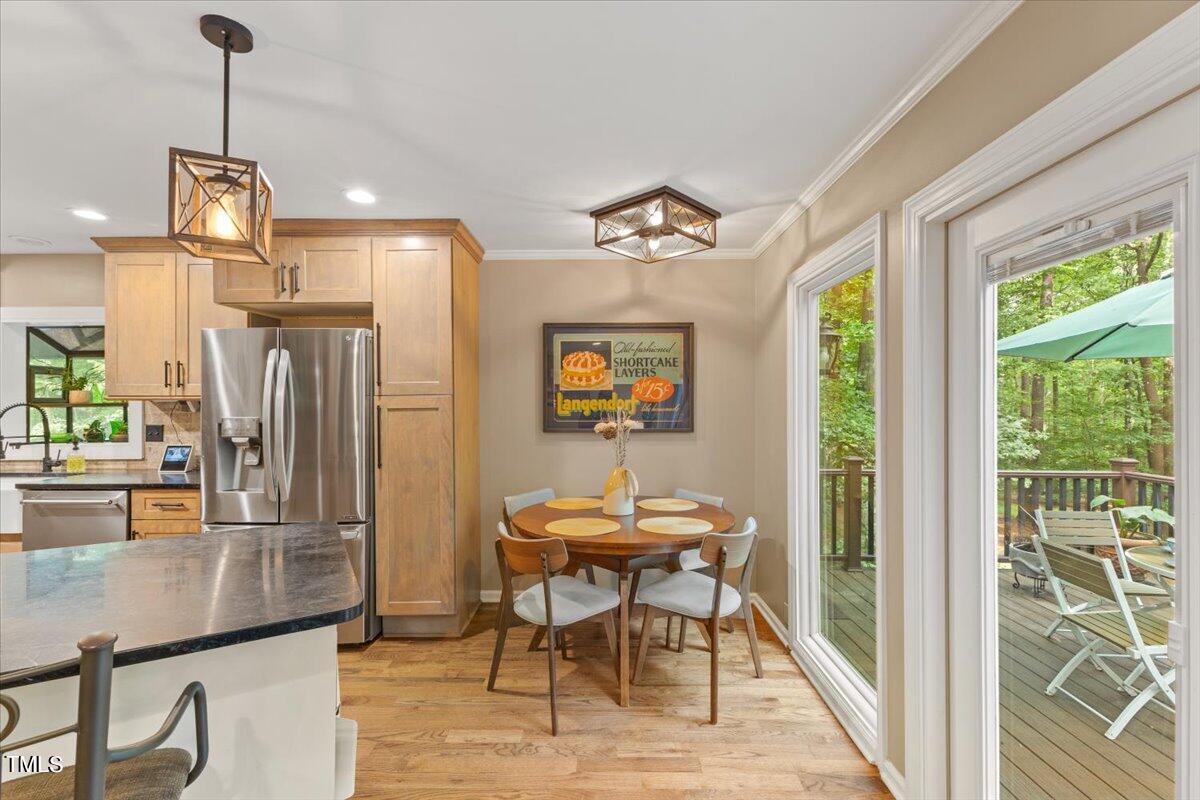 6713 Laurdane Road Raleigh, NC 27613 - Photo 13 of 47 a view of a dining room with furniture window and outside view