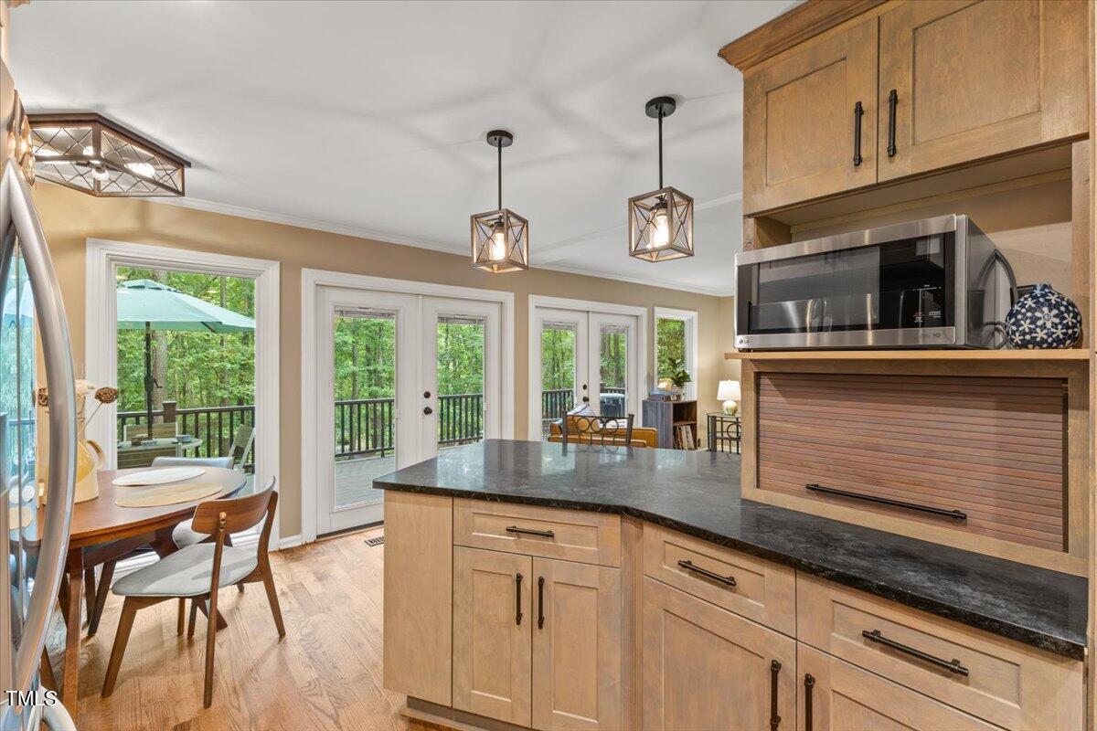 6713 Laurdane Road Raleigh, NC 27613 - Photo 16 of 47 a kitchen with sink cabinets and outdoor view
