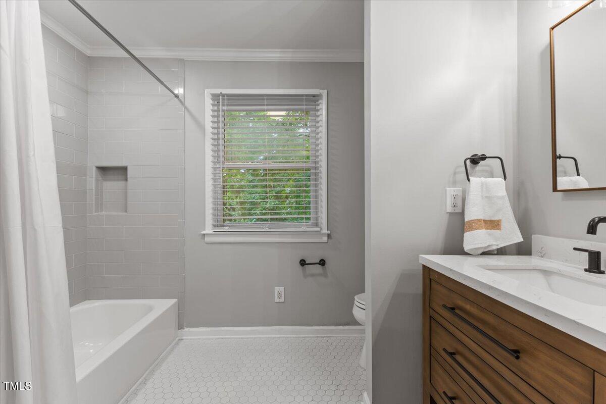 6713 Laurdane Road Raleigh, NC 27613 - Photo 22 of 47 a bathroom with a granite countertop sink and a bathtub