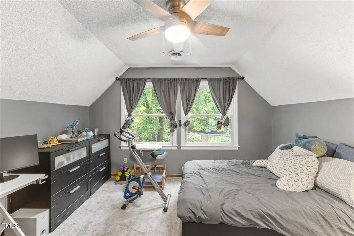 6713 Laurdane Road Raleigh, NC 27613 - Photo 23 of 47 a bedroom with a bed and a chandelier