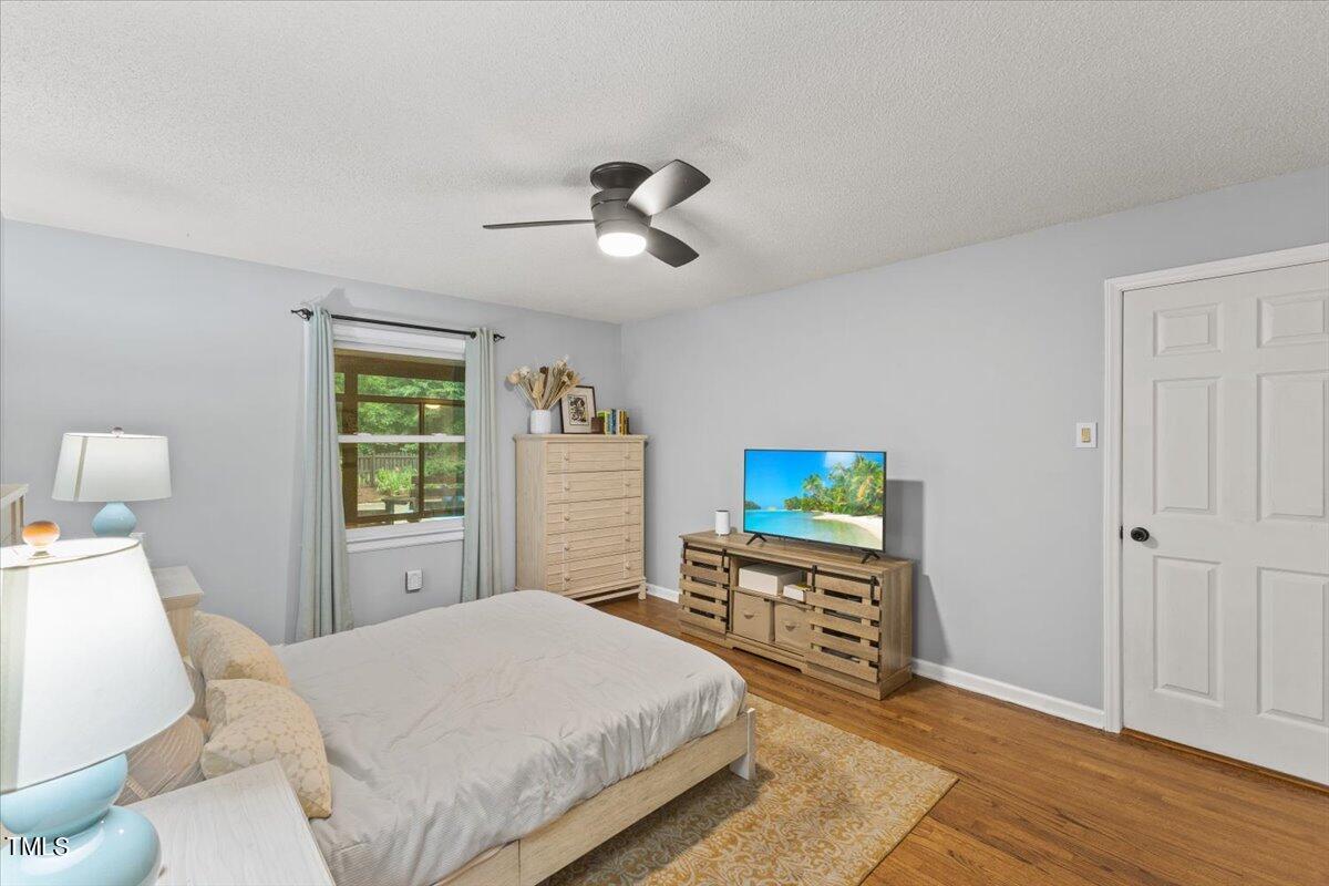 6713 Laurdane Road Raleigh, NC 27613 - Photo 25 of 47 a bedroom with a bed and a flat screen tv