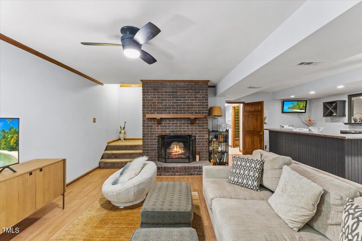 6713 Laurdane Road Raleigh, NC 27613 - Photo 27 of 47 a living room with furniture and a fireplace