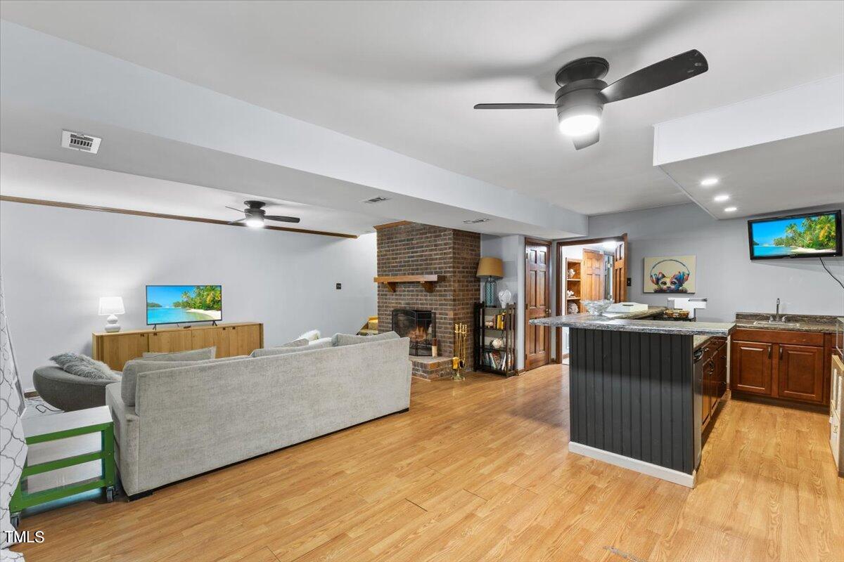 6713 Laurdane Road Raleigh, NC 27613 - Photo 28 of 47 a living room with furniture and a flat screen tv