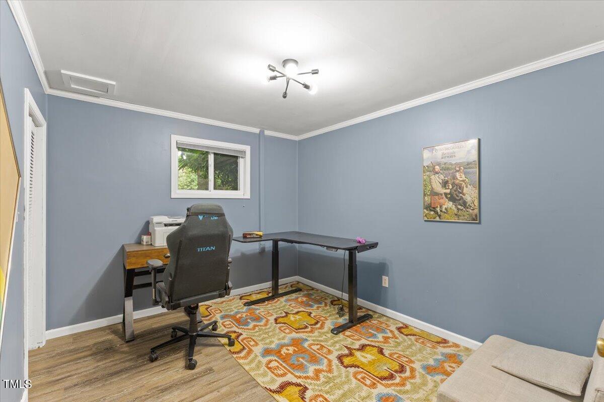 6713 Laurdane Road Raleigh, NC 27613 - Photo 31 of 47 a room that has a window and wooden floor