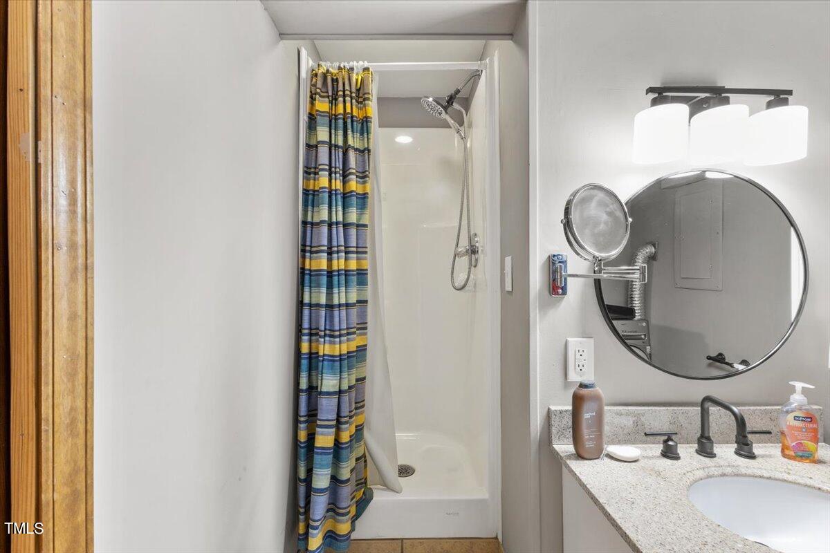 6713 Laurdane Road Raleigh, NC 27613 - Photo 32 of 47 a bathroom with a sink and a mirror