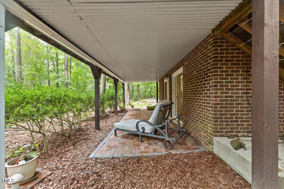 6713 Laurdane Road Raleigh, NC 27613 - Photo 35 of 47 a view of a patio with chair and tables back yard of the house