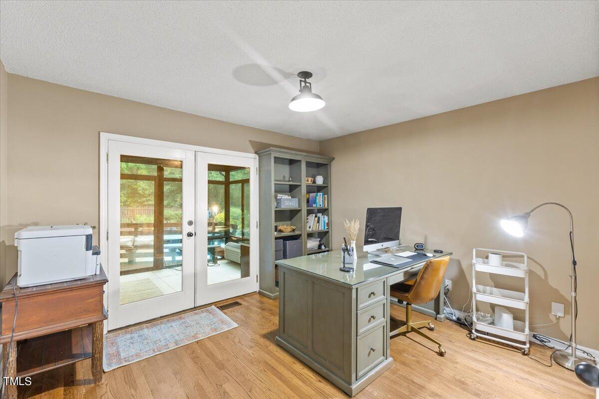 6713 Laurdane Road Raleigh, NC 27613 - Photo 37 of 47 a view of a workspace with furniture and a window