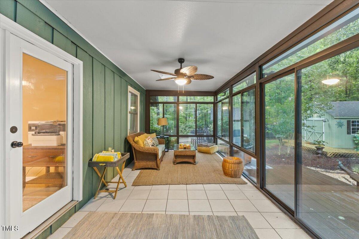 6713 Laurdane Road Raleigh, NC 27613 - Photo 38 of 47 a living room with furniture and a floor to ceiling window