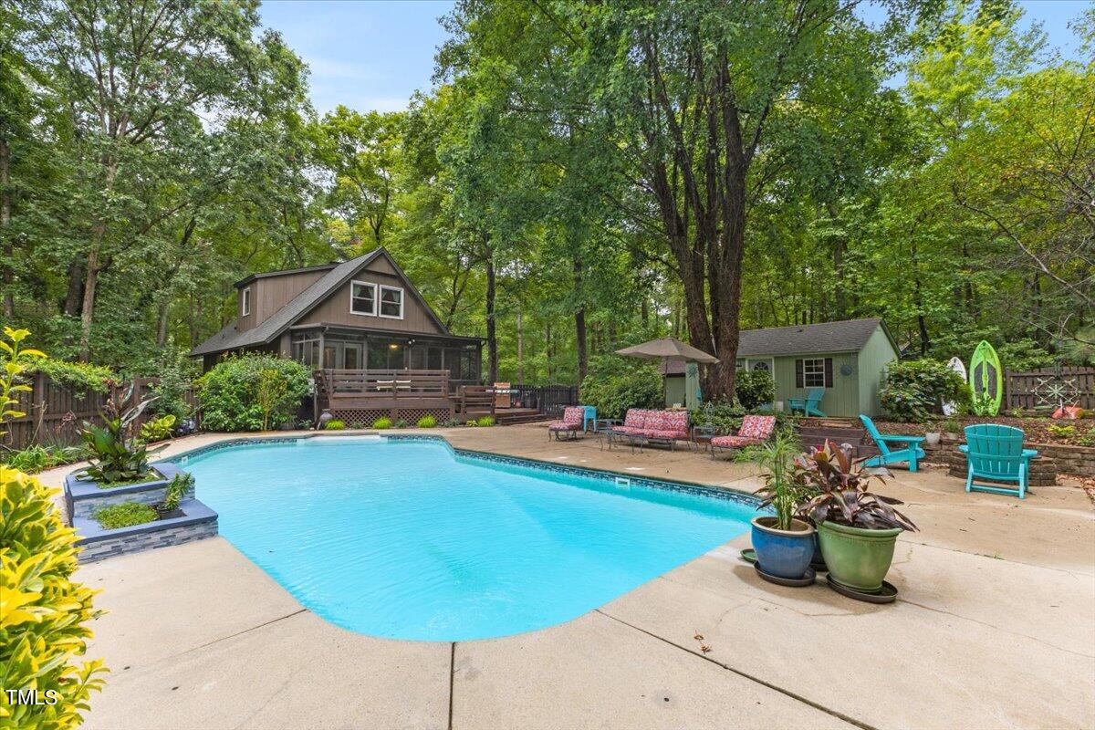 6713 Laurdane Road Raleigh, NC 27613 - Photo 43 of 47 a small pool with table and chairs potted plants and large trees