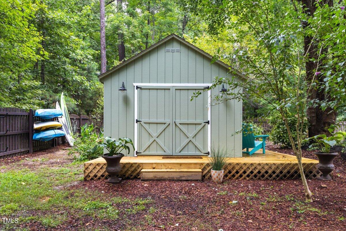 6713 Laurdane Road Raleigh, NC 27613 - Photo 46 of 47 a backyard of a house with table and chairs