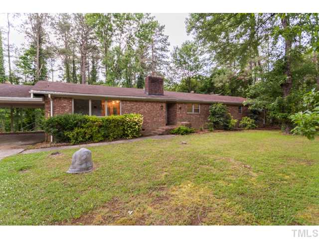 11709 Strickland Road Raleigh, NC 27613 - Photo 2 of 25 a house view with a garden space
