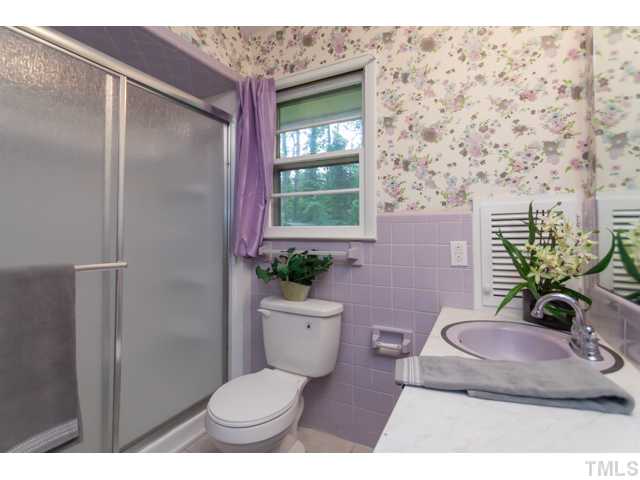 11709 Strickland Road Raleigh, NC 27613 - Photo 12 of 25 a bathroom with a toilet and a sink