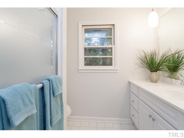 11709 Strickland Road Raleigh, NC 27613 - Photo 15 of 25 a bathroom with a sink and a mirror