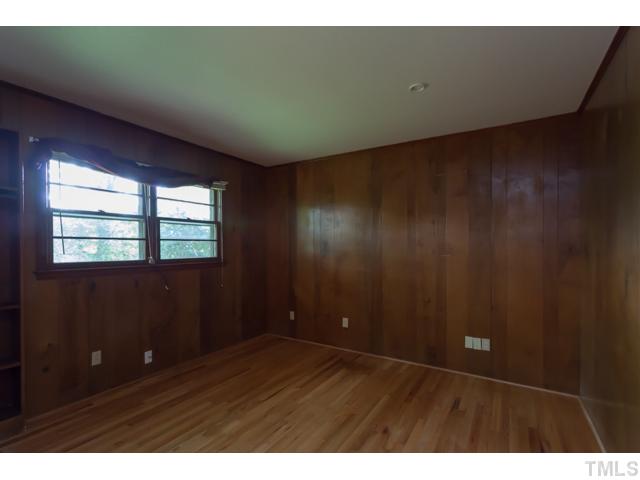 11709 Strickland Road Raleigh, NC 27613 - Photo 16 of 25 a view of an empty room with wooden floor and a window
