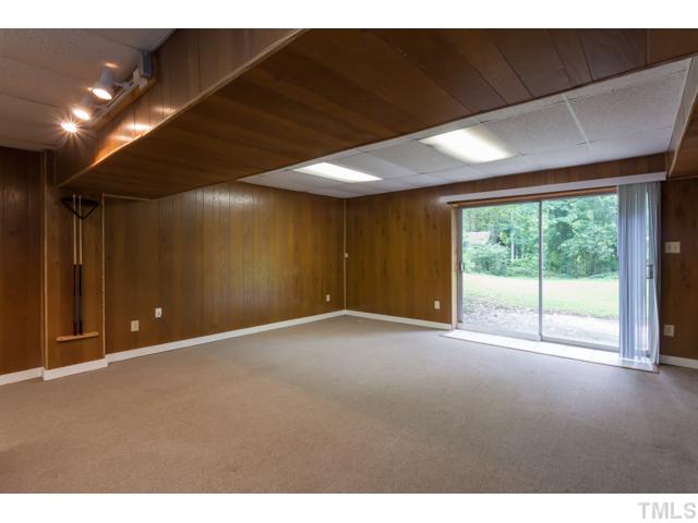 11709 Strickland Road Raleigh, NC 27613 - Photo 18 of 25 a view of an empty room with a window