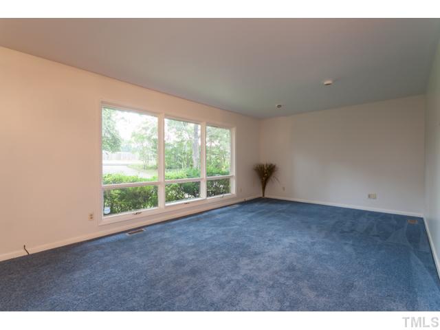 11709 Strickland Road Raleigh, NC 27613 - Photo 3 of 25 a view of an empty room with a window