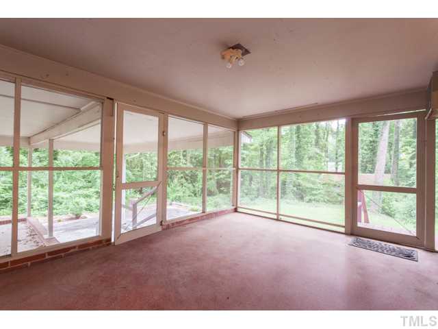 11709 Strickland Road Raleigh, NC 27613 - Photo 22 of 25 a view of an empty room with a large window